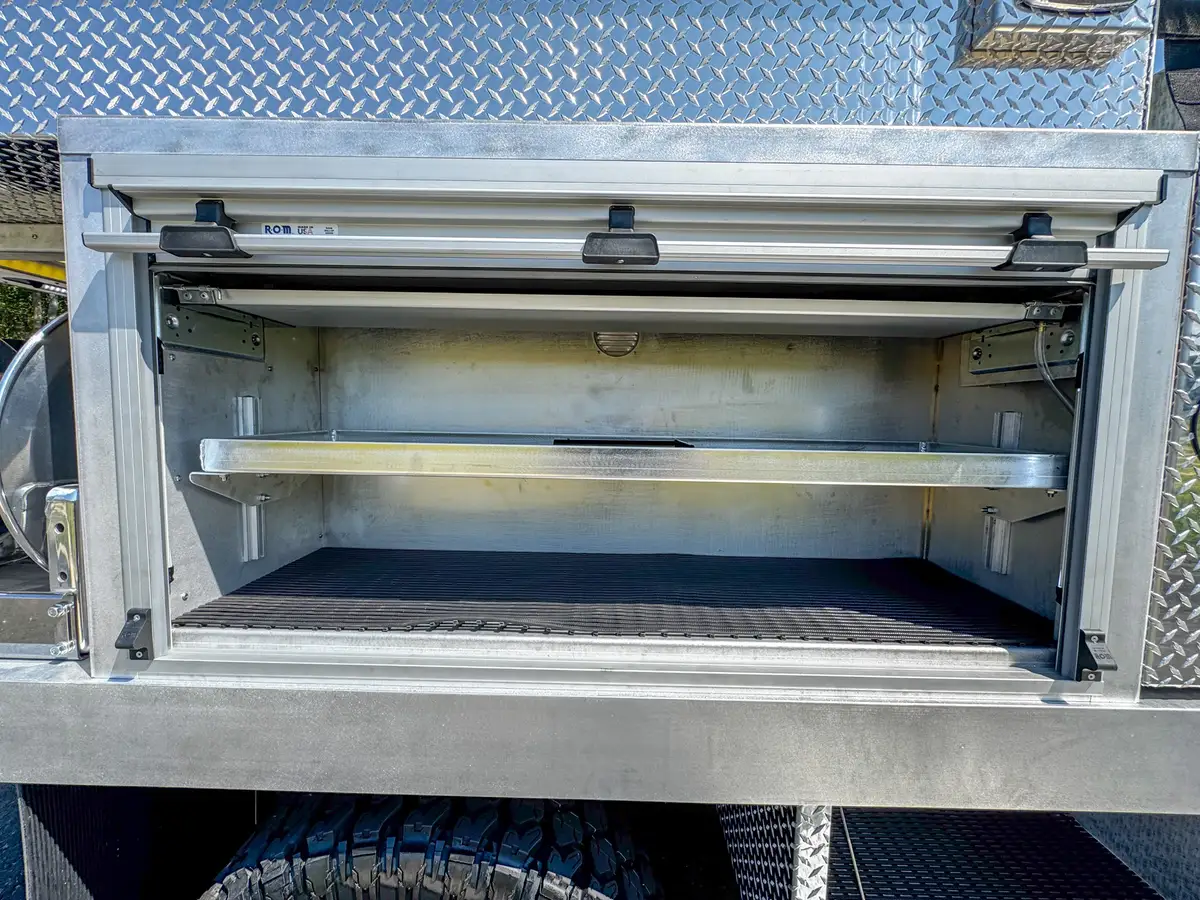 Long right-side compartment interior close-up with shelf and liner.